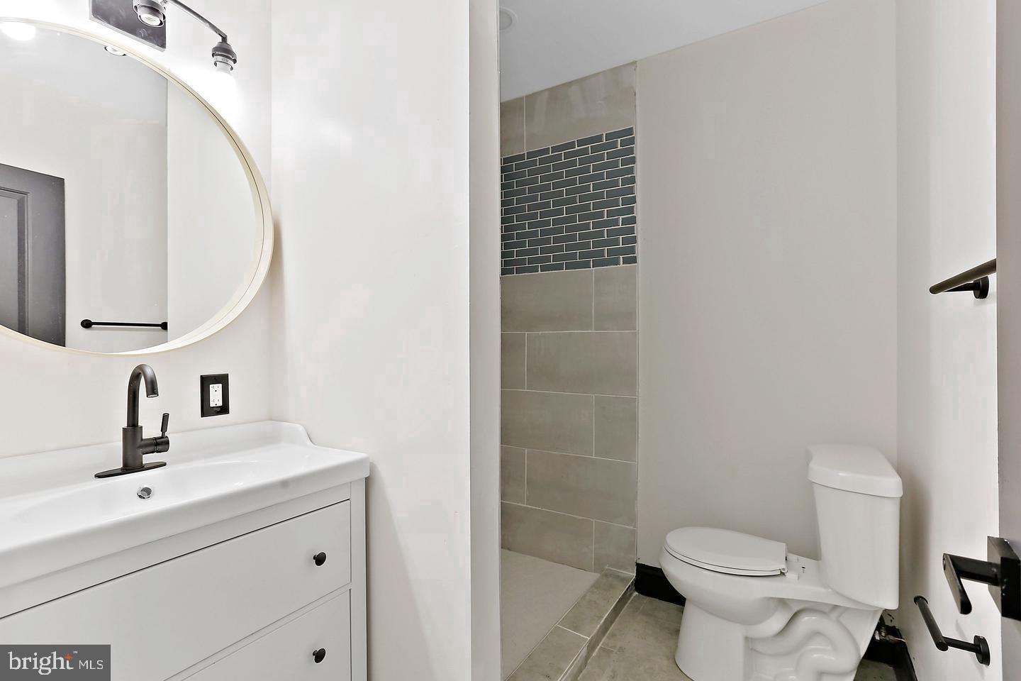 1732 McCulloh Street Baltimore, MD 21217 - Photo 16 of 30 a bathroom with a sink a toilet and shower