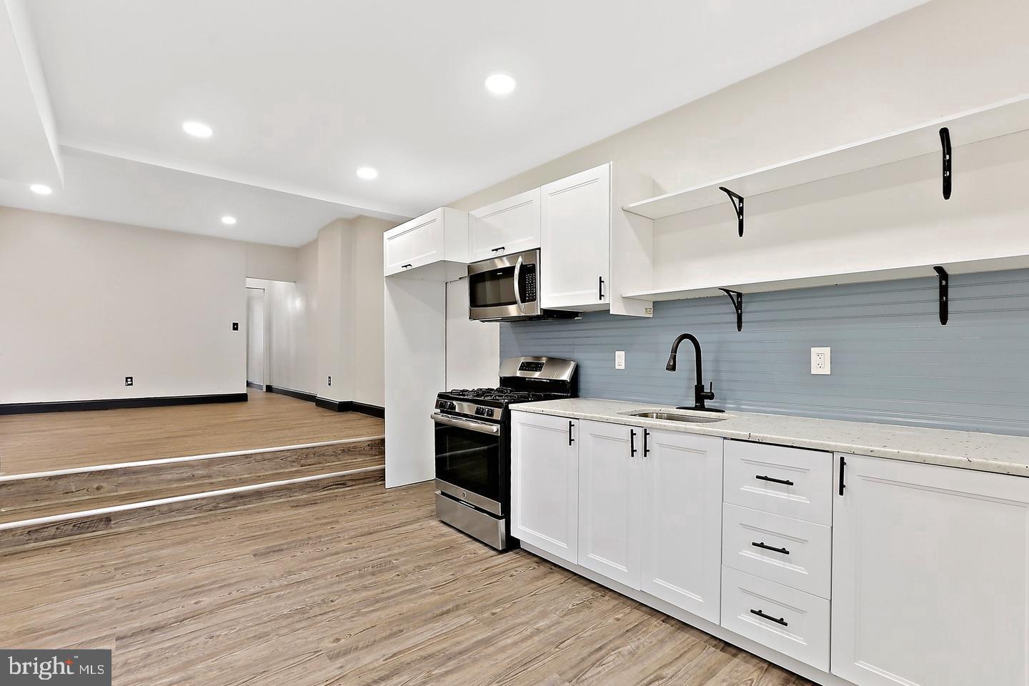 1732 McCulloh Street Baltimore, MD 21217 - Photo 25 of 30 a kitchen with cabinets oven a sink and dishwasher