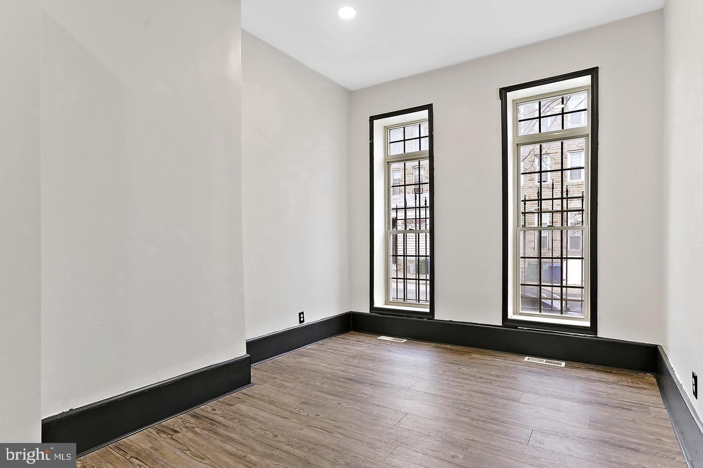 1732 McCulloh Street Baltimore, MD 21217 - Photo 4 of 30 an empty room with wooden floor and windows
