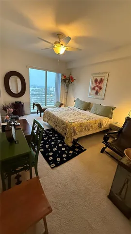 a bed room with a bed mirror and a desk