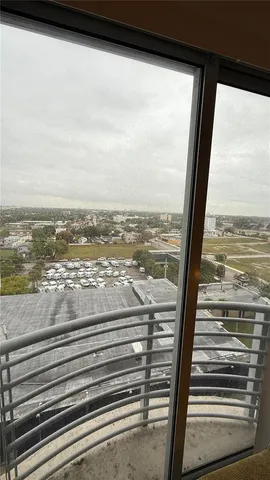 a view of a balcony next to a yard