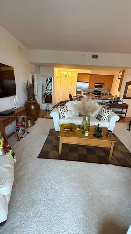 a bed sitting in a room next to a lamp