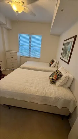 a bedroom with a bed and painting on the wall