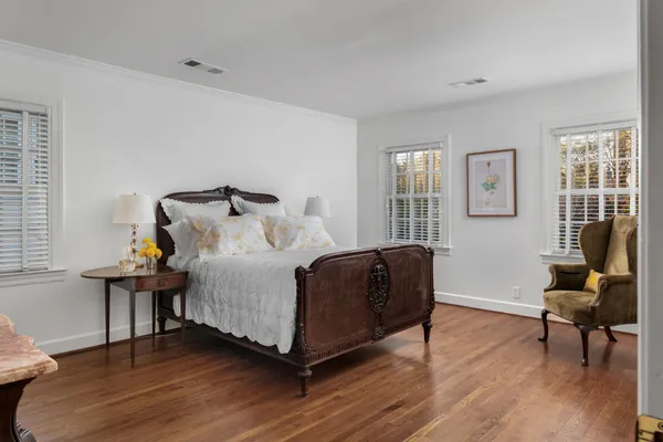 a bed room with a bed and a chair