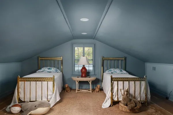 a bedroom with furniture and a window