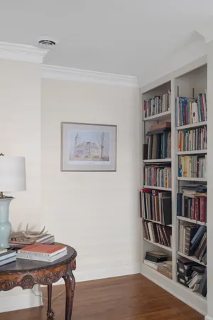 a view of a workspace with furniture and wooden floor