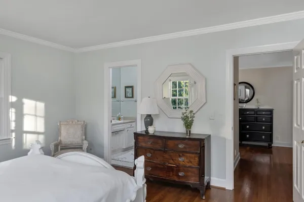 a bedroom with furniture and a mirror