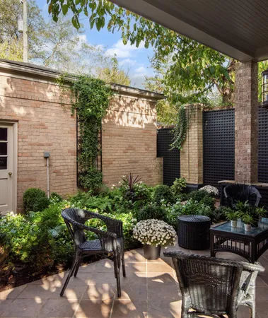 a view of a backyard with chair and potted plants