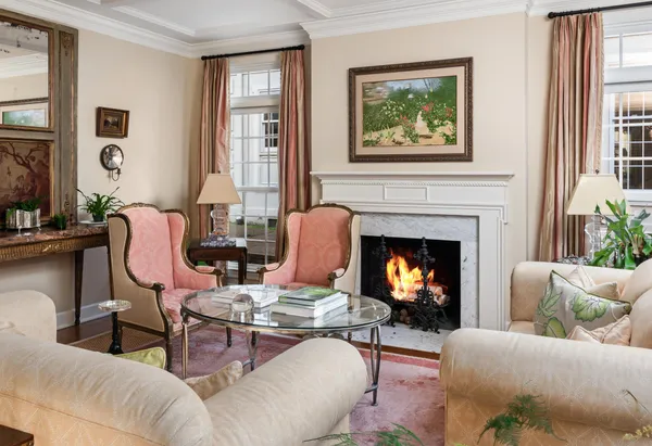 a living room with furniture a fireplace and windows