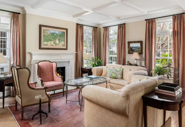 a living room with furniture fireplace and a large window