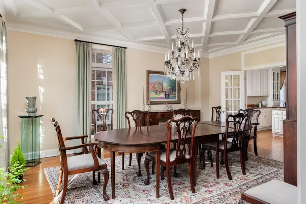 a view of a dining room with furniture and chandelier