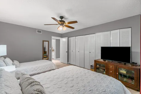 a bedroom with a bed and a flat screen tv