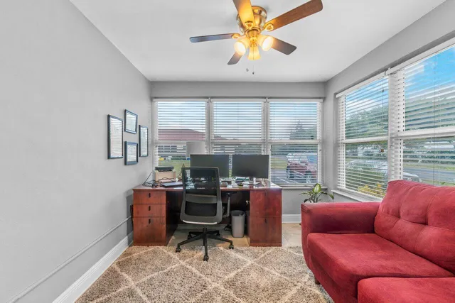 a living room with furniture a large window and a chandelier