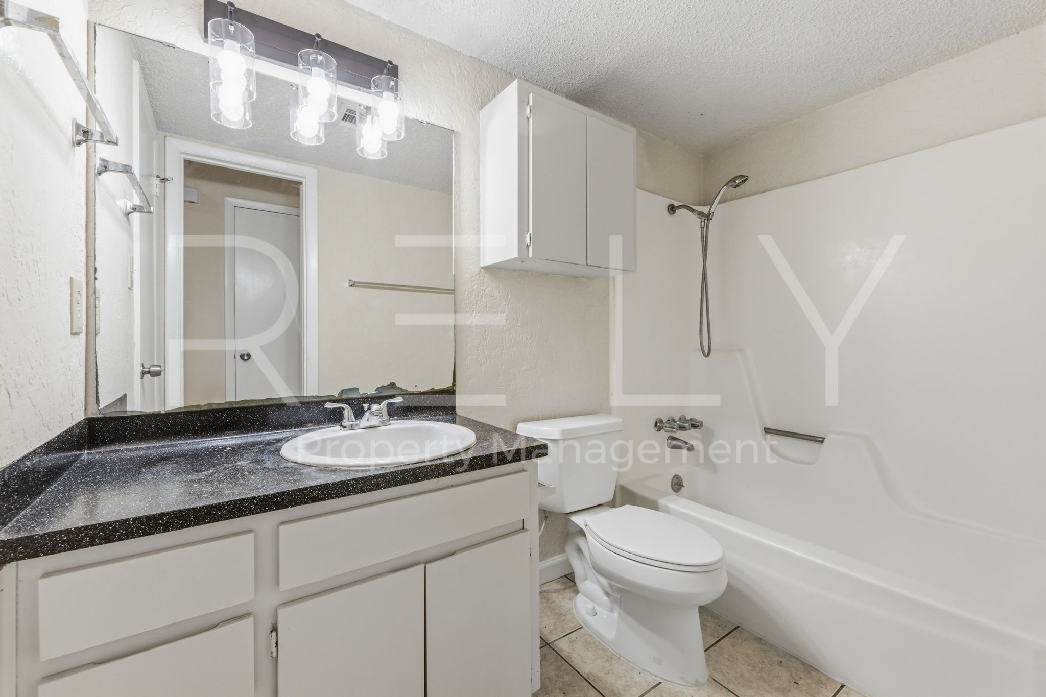 1005 Milford Way, Unit A Austin, TX 78745 - Photo 17 of 30 a bathroom with a granite countertop sink mirror vanity and toilet