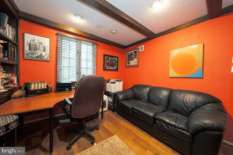 a living room with furniture workspace and a large window
