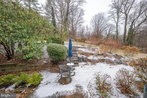 a view of a patio with table and chairs with wooden fence and plants