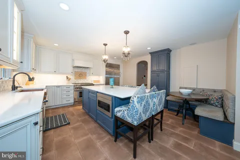 a stove top oven sitting inside of a kitchen