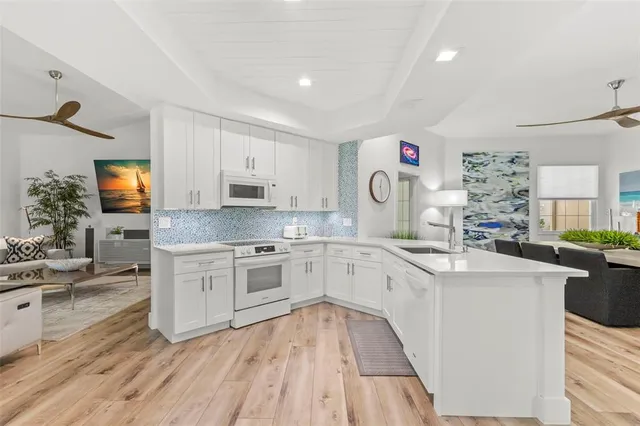 a kitchen with granite countertop a sink stove and cabinets