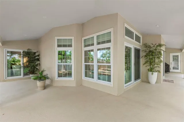 a view of an house with potted plants and a large window