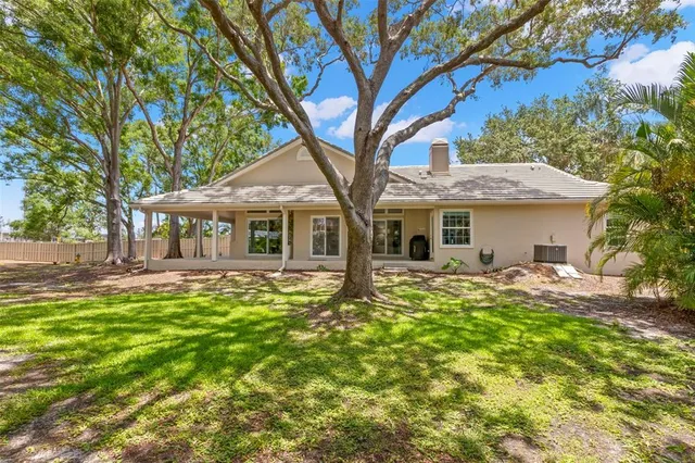 a front view of a house with swimming pool having outdoor seating