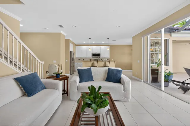 a living room with furniture and a view of kitchen