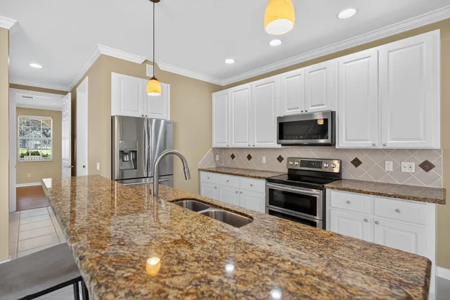 a utility room with sink dryer and washer