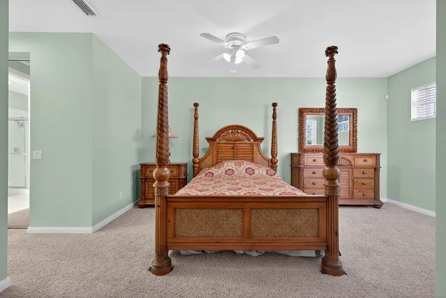 a spacious bathroom with a granite countertop tub sink and mirror