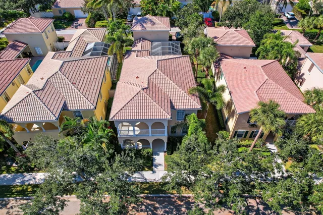 an aerial view of a house with a garden and lake view