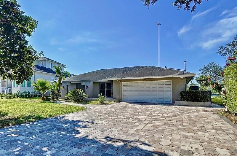 3901 East Eden Roc Circle Tampa, FL 33634 - Photo 1 of 1 a front view of a house with a yard and garage