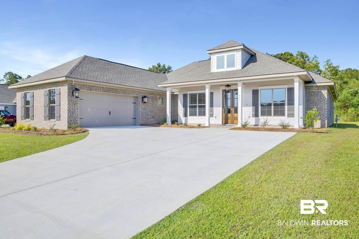 393 Garrison Boulevard Fairhope, AL 36532 - Photo 1 of 40 View of front facade featuring a garage, a porch, and a front lawn
