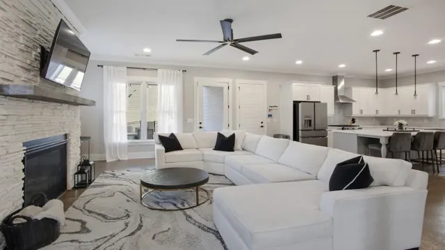 a living room with furniture a fireplace and a flat screen tv