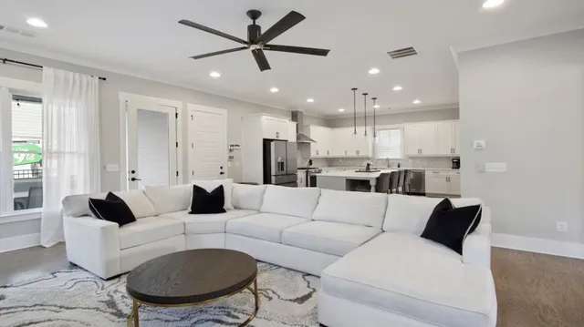 a living room with furniture a fireplace and a flat screen tv