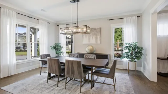 a kitchen with stainless steel appliances granite countertop a sink a stove a refrigerator and island with wooden floor