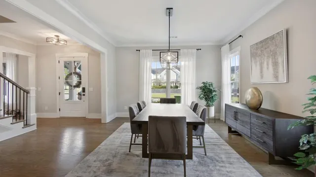 a kitchen with a sink a center island stainless steel appliances and cabinets