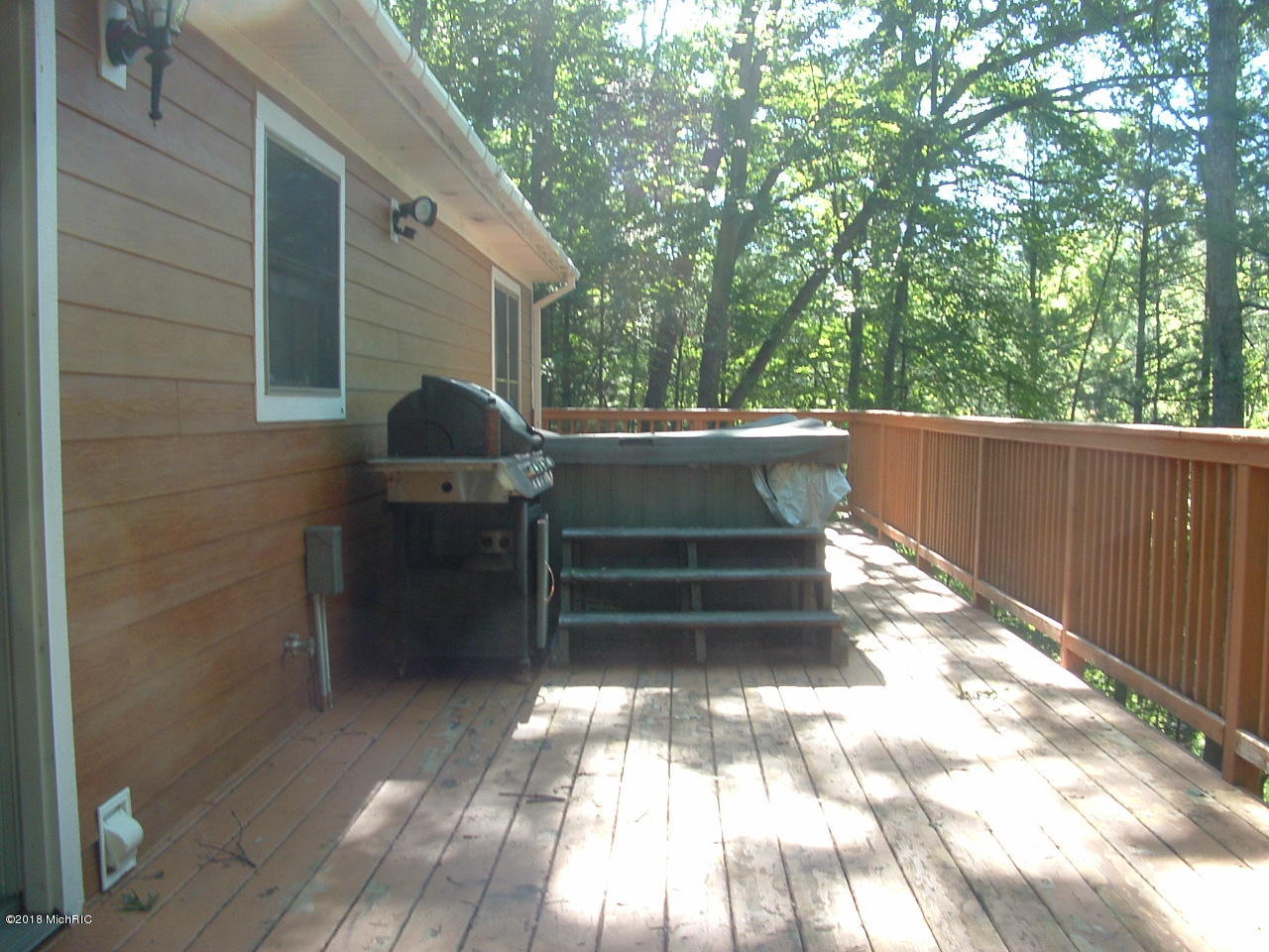 7887 West Peterson Road Irons, MI 49644 - Photo 5 of 14 Deck with Hot Tub