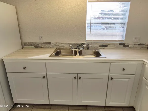 a kitchen with a sink and cabinets