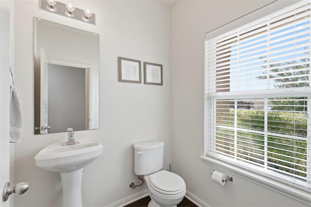 14229 Bridgeview Lane Dallas, TX 75253 - Photo 12 of 29 a bathroom with a sink a toilet and a window