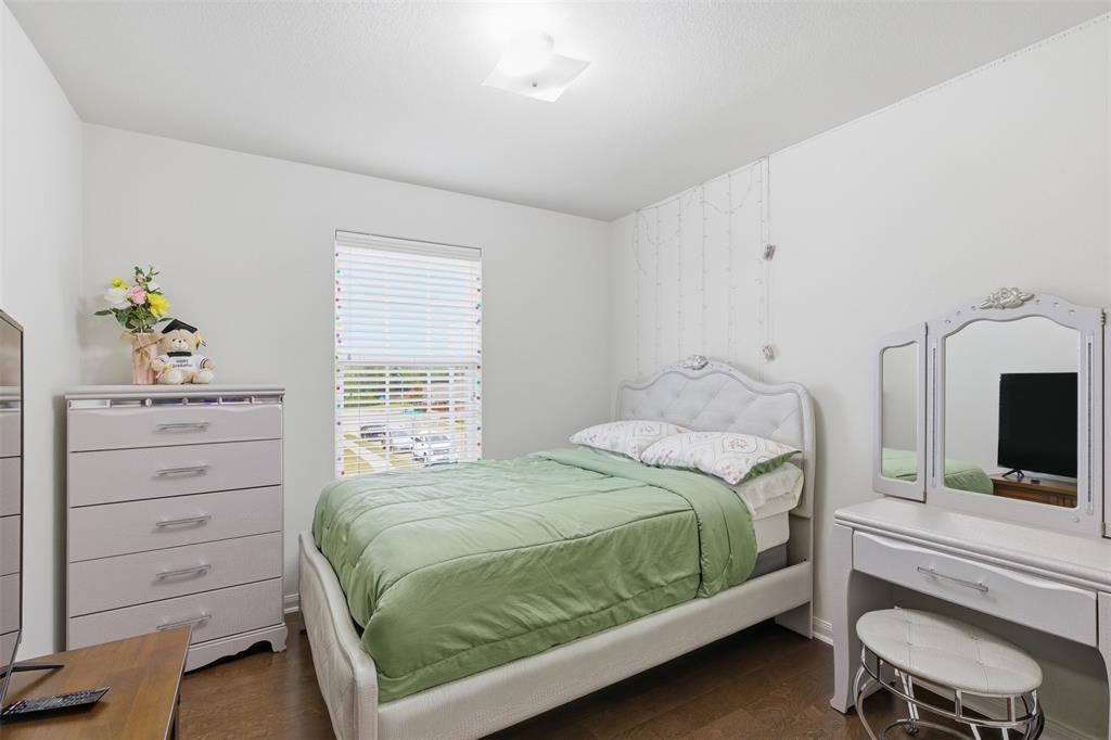 14229 Bridgeview Lane Dallas, TX 75253 - Photo 15 of 29 a bedroom with a bed and a flat screen tv