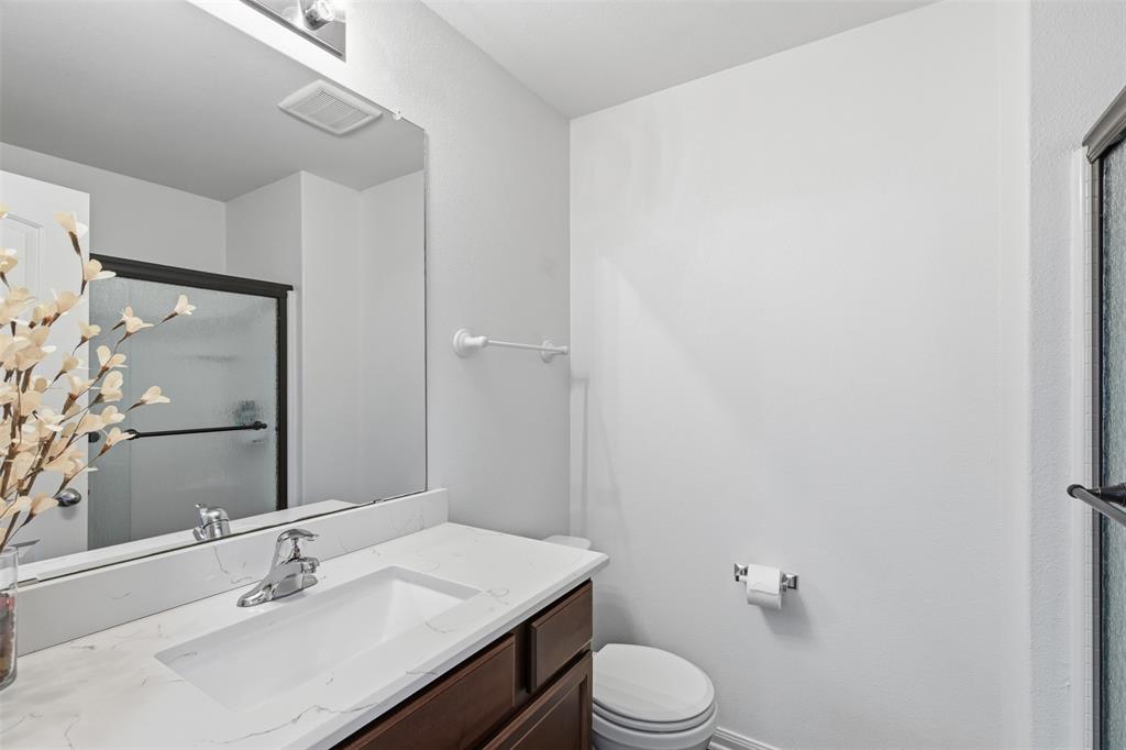 14229 Bridgeview Lane Dallas, TX 75253 - Photo 16 of 29 a bathroom with a sink toilet and mirror