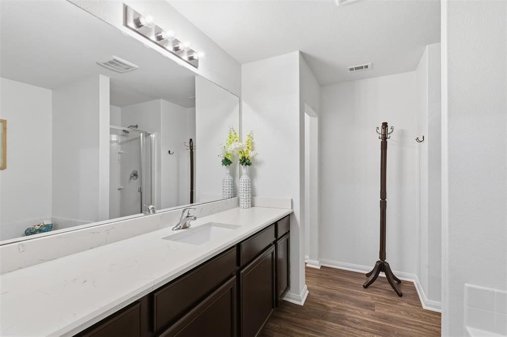 14229 Bridgeview Lane Dallas, TX 75253 - Photo 20 of 29 a bathroom with a double vanity sink and a mirror