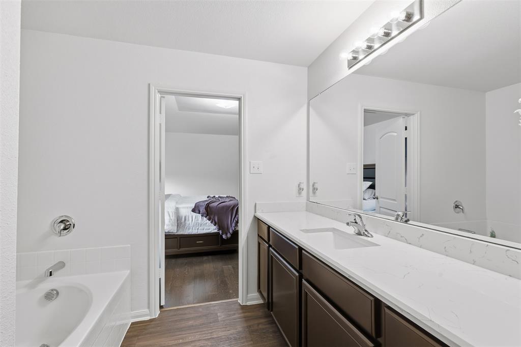 14229 Bridgeview Lane Dallas, TX 75253 - Photo 21 of 29 a en suite bathroom with a sink double vanity and a tub