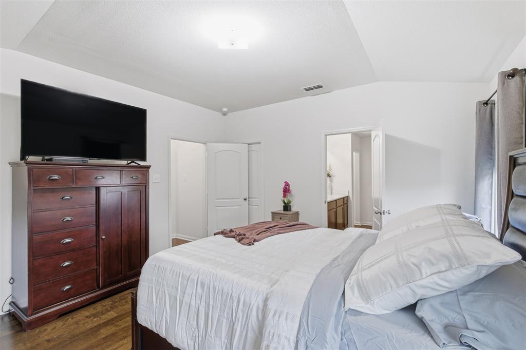 14229 Bridgeview Lane Dallas, TX 75253 - Photo 23 of 29 a bedroom with a bed and a flat screen tv