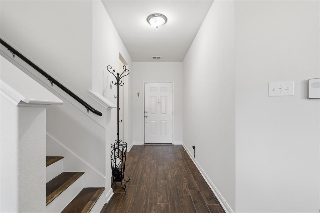 14229 Bridgeview Lane Dallas, TX 75253 - Photo 4 of 29 a view of a hallway with wooden floor and staircase