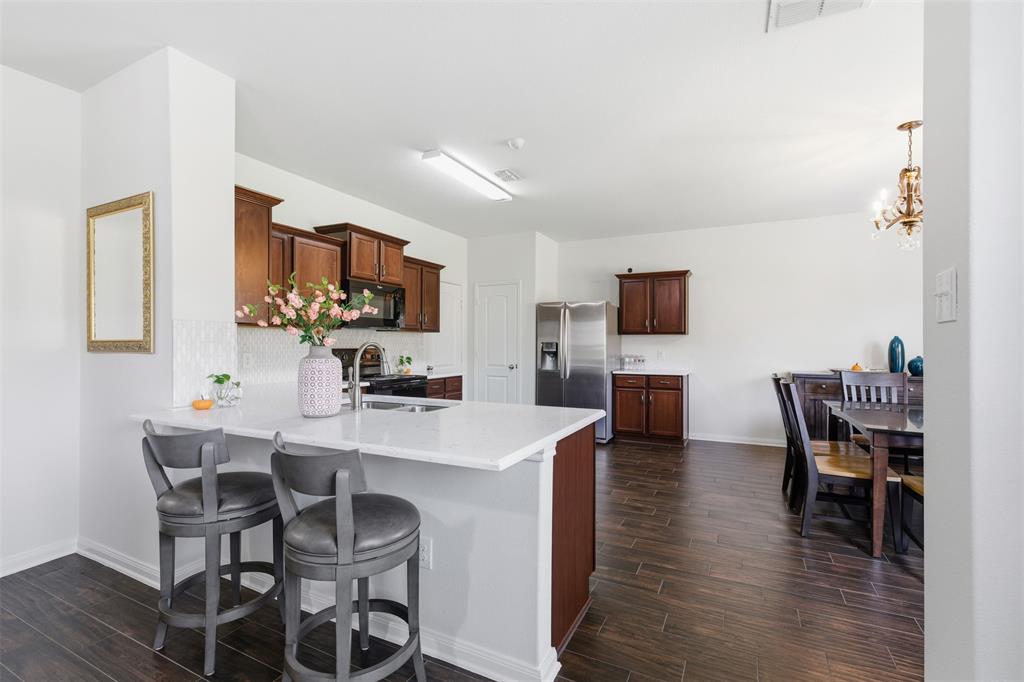 14229 Bridgeview Lane Dallas, TX 75253 - Photo 8 of 29 a view of a dining room with furniture and wooden floor
