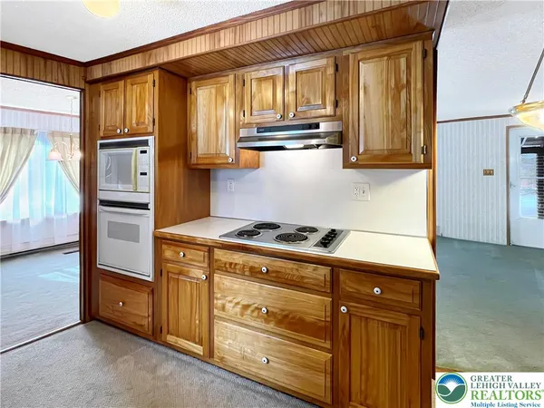 a kitchen with granite countertop wooden cabinets and stainless steel appliances