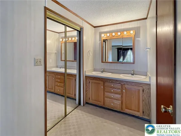 a bathroom with a double vanity sink and mirror