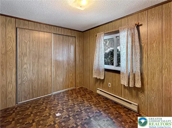 a view of a hallway with wooden walls and windows
