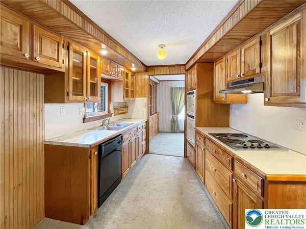 a kitchen with stainless steel appliances granite countertop a stove and a sink