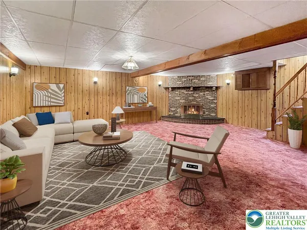 a living room with furniture a rug and white walls