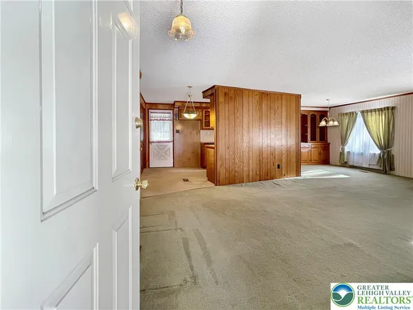 a view of a livingroom with wooden floor and cabinet